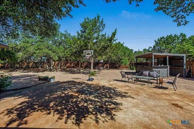 10 Long Bow Ln, Wimberley, TX 78676 - fenced backyard with a patio and a jacuzzi
