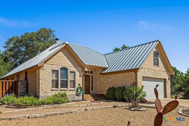 10 Long Bow Ln, Wimberley, TX 78676 - view of front of property featuring stone siding, a standing seam roof, a metal roof, and concrete driveway