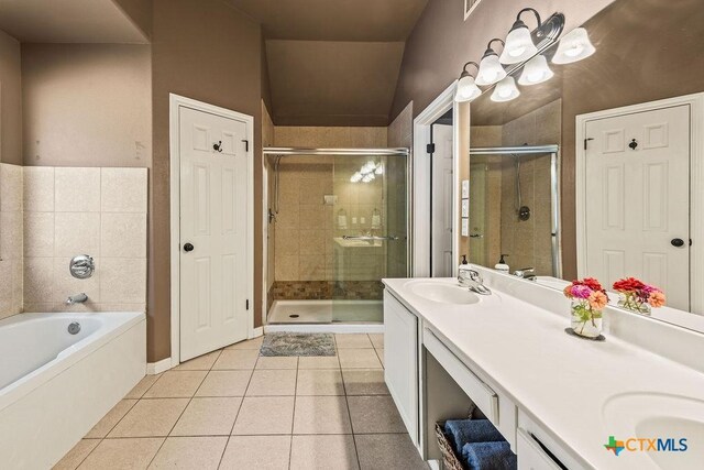 10 Long Bow Ln, Wimberley, TX 78676 - bathroom with double vanity, tile patterned floors, a stall shower, and a garden tub