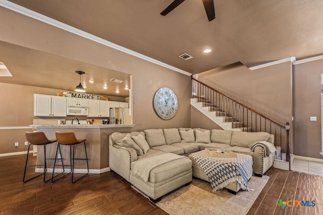 10 Long Bow Ln, Wimberley, TX 78676 - living room with ornamental molding, a ceiling fan, dark wood-style floors, stairs, and recessed lighting