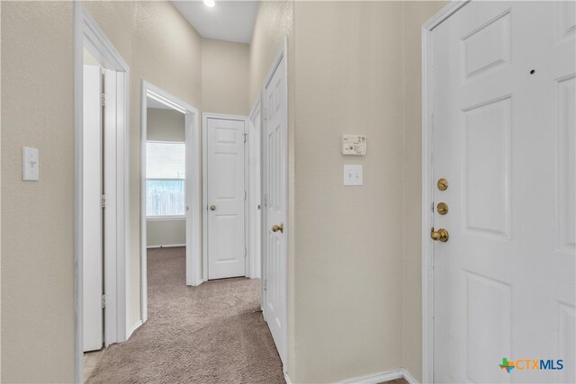 hallway with light colored carpet