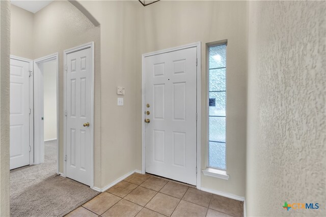 foyer entrance with light tile patterned flooring