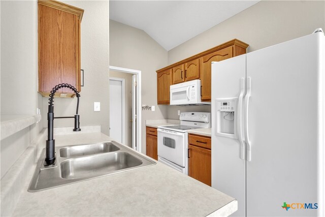 kitchen with lofted ceiling, sink, and white appliances