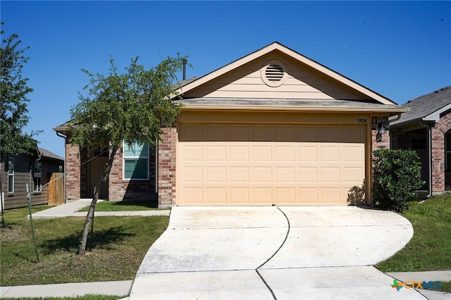 ranch-style house featuring a garage and a front yard