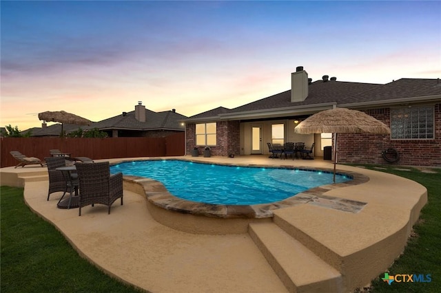 2017 Wagon Gap Rd, Temple, TX 76502 - pool at dusk featuring a fenced in pool, fence, and a patio area