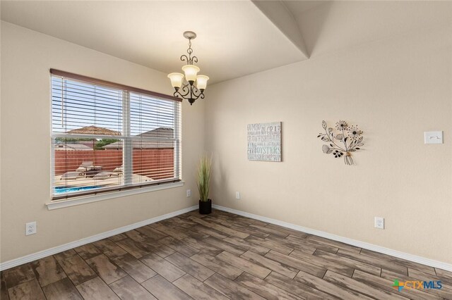 2017 Wagon Gap Rd, Temple, TX 76502 - spare room with baseboards, wood finish floors, and a notable chandelier