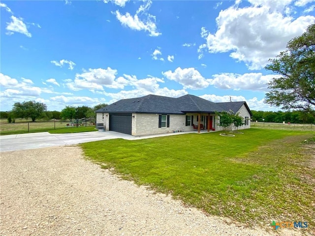 view of front of property featuring a front lawn and a garage