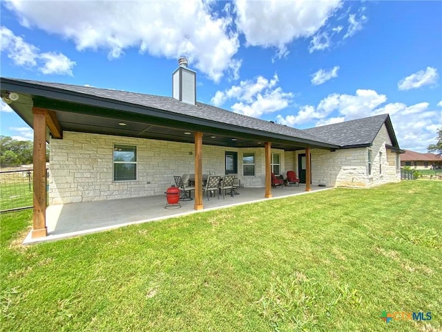 back of property featuring a yard and a patio area