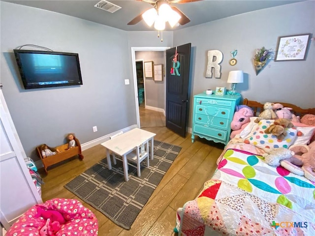 bedroom with ceiling fan and hardwood / wood-style flooring