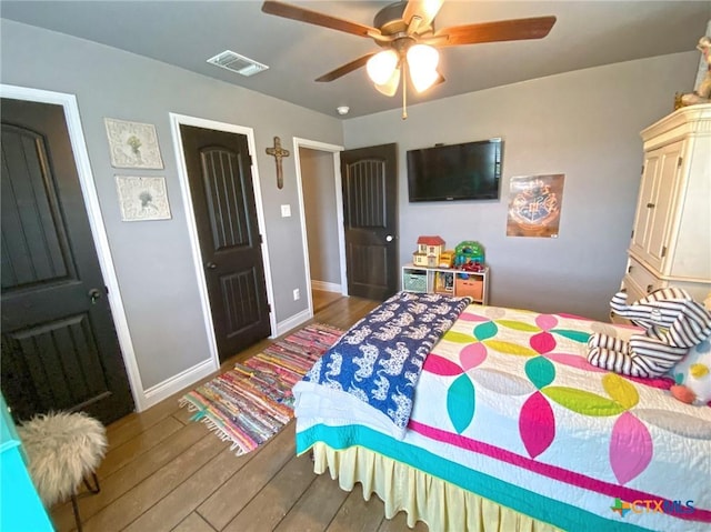 bedroom with ceiling fan and hardwood / wood-style flooring