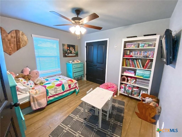 bedroom featuring wood-type flooring and ceiling fan