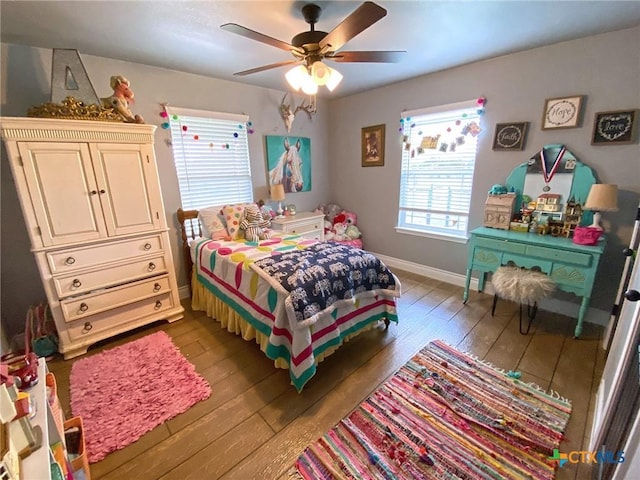 bedroom featuring a ceiling fan, hardwood / wood-style flooring, and baseboards