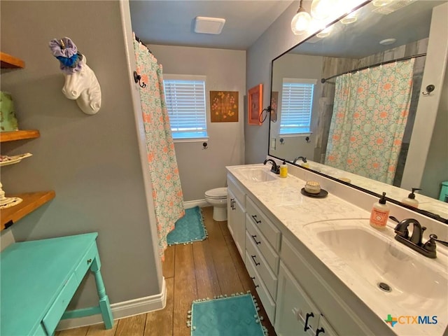 bathroom featuring hardwood / wood-style floors, vanity, and toilet