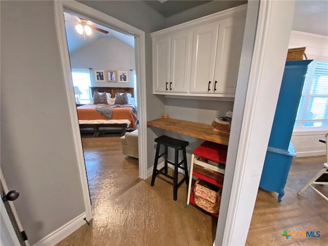 interior space with light hardwood / wood-style flooring, vaulted ceiling, and ceiling fan