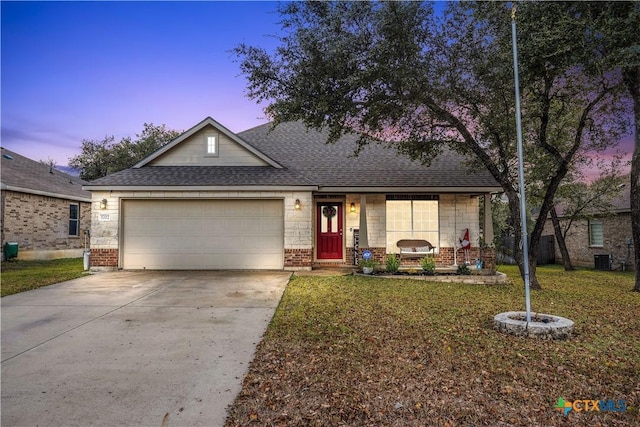 single story home with a yard and a garage