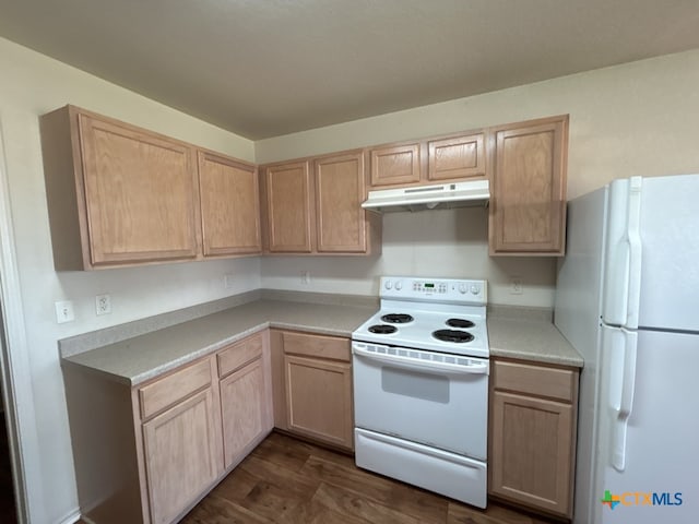 kitchen with dark wood-type flooring, light brown cabinets, and white appliances