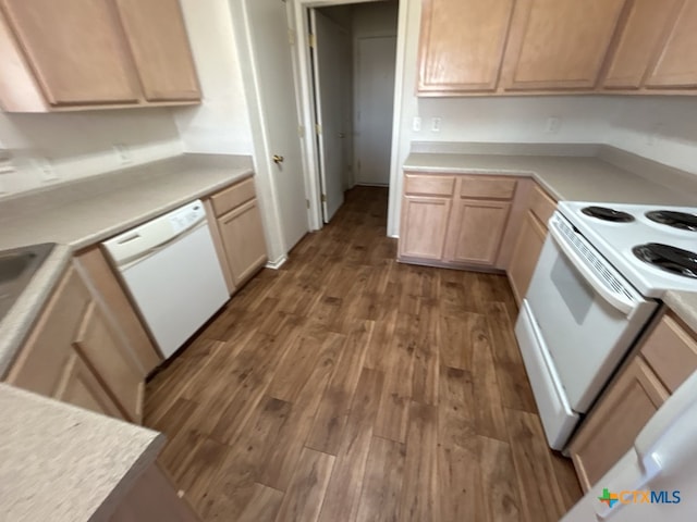 kitchen featuring dark wood-type flooring, light brown cabinetry, and white appliances