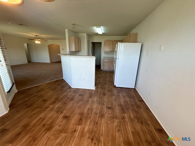 kitchen featuring light brown cabinets, ceiling fan, white fridge, and dark hardwood / wood-style flooring