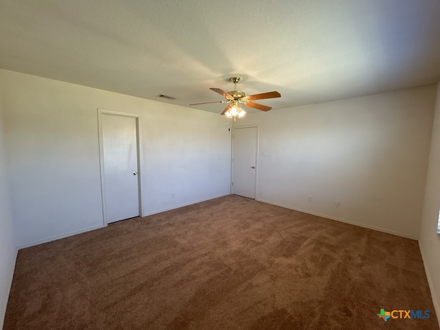 carpeted spare room with ceiling fan