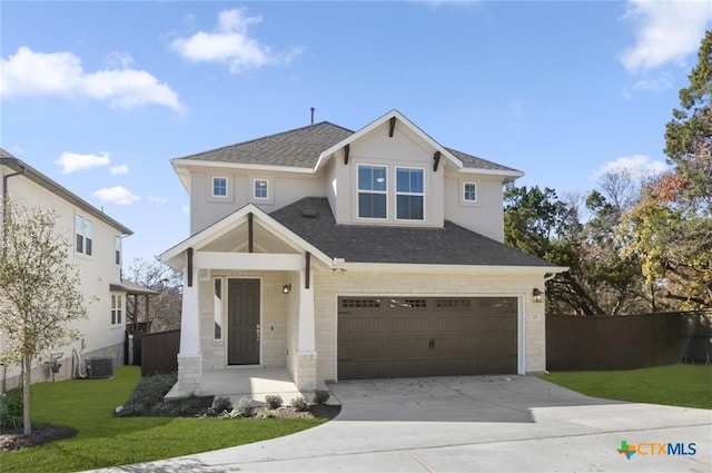 view of front of home featuring central AC, a front lawn, and a garage