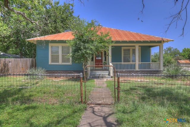 bungalow-style house featuring a front yard and covered porch