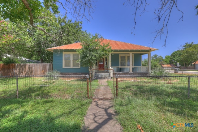 view of front of house featuring a front yard and covered porch