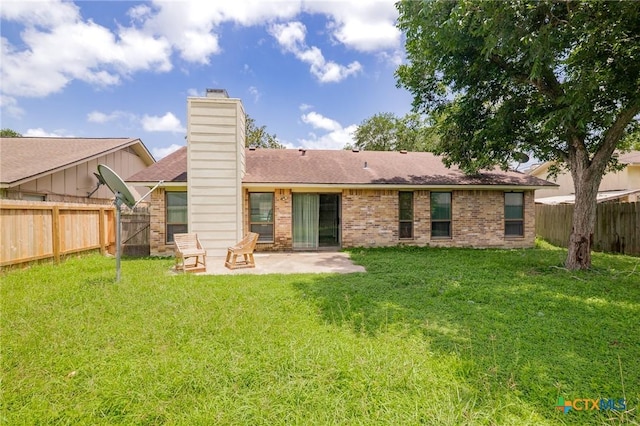 515 Camelot Dr, Victoria, TX 77901 - rear view of house with a patio, brick siding, a fenced backyard, and a chimney