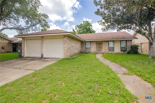 515 Camelot Dr, Victoria, TX 77901 - ranch-style house with a garage, driveway, brick siding, and a front yard
