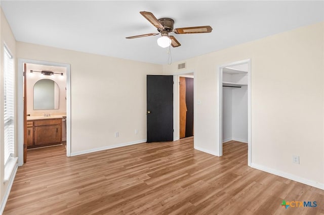 515 Camelot Dr, Victoria, TX 77901 - unfurnished bedroom with light wood finished floors, a closet, connected bathroom, and ceiling fan