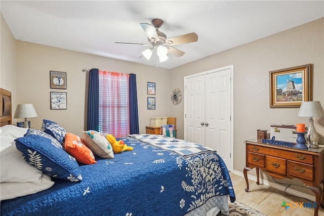 bedroom featuring ceiling fan, light hardwood / wood-style floors, and a closet