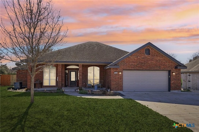 ranch-style home with a yard and a garage