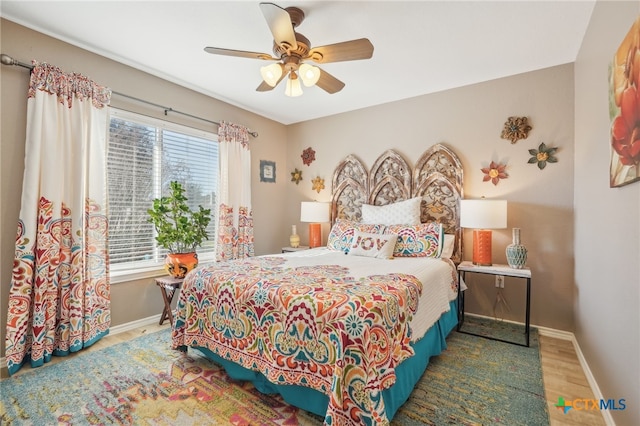 bedroom featuring hardwood / wood-style flooring and ceiling fan