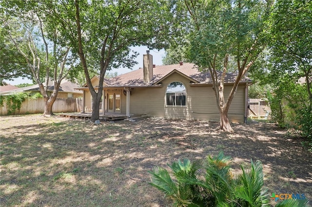 back of property featuring a deck