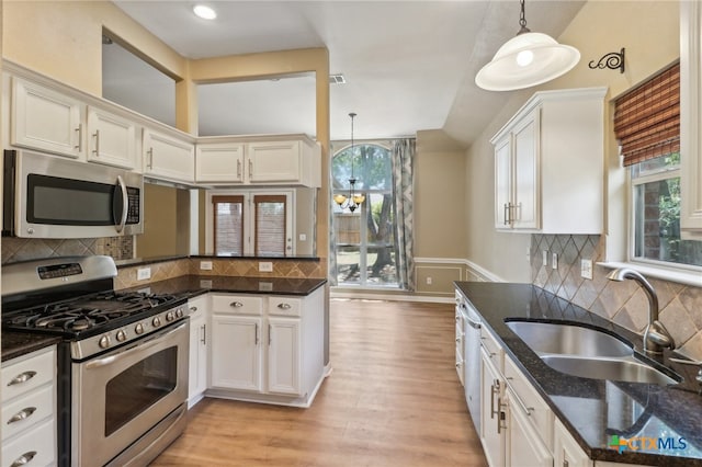 kitchen featuring a wealth of natural light, pendant lighting, and appliances with stainless steel finishes