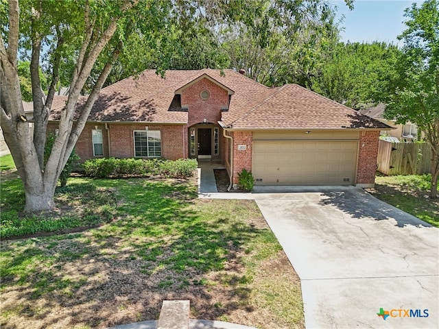 view of front of property with a garage and a front yard