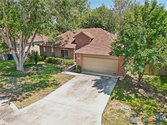 view of front of house with a garage and a front lawn