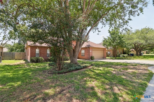 view of front of home with a garage and a front lawn