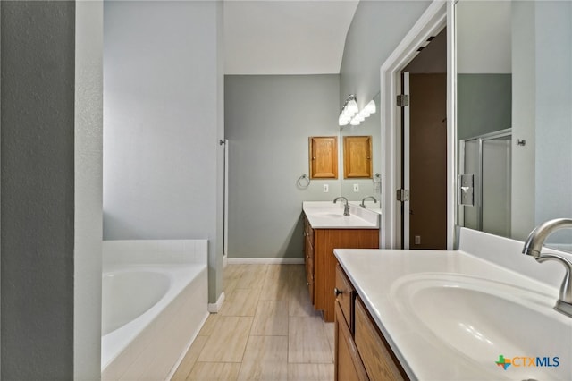 bathroom featuring independent shower and bath, vanity, and tile patterned flooring