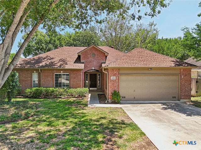 ranch-style house with a garage and a front yard