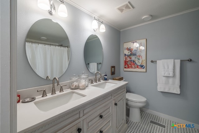 bathroom with toilet, vanity, and crown molding