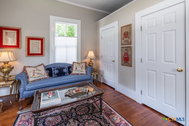 living room with dark hardwood / wood-style floors and crown molding