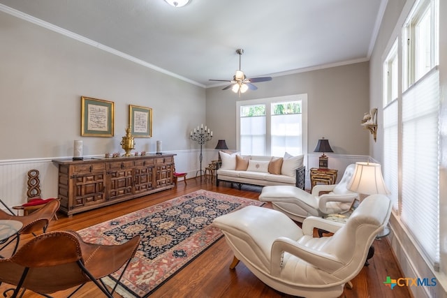 living room featuring ceiling fan, hardwood / wood-style floors, and ornamental molding