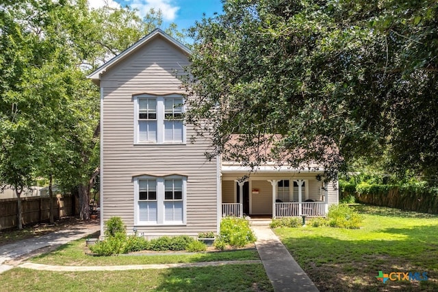 view of front of house featuring a porch and a front yard