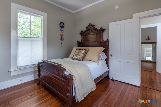 bedroom with dark hardwood / wood-style flooring and crown molding