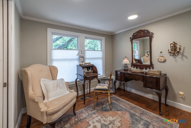 sitting room featuring ornamental molding and wood-type flooring