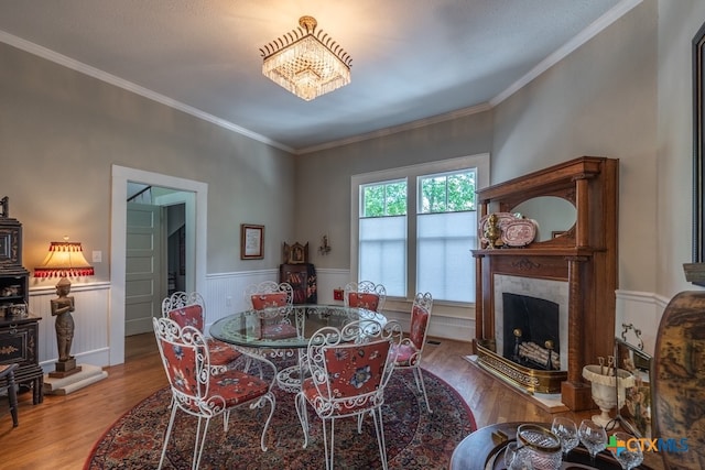 dining space featuring hardwood / wood-style flooring and crown molding