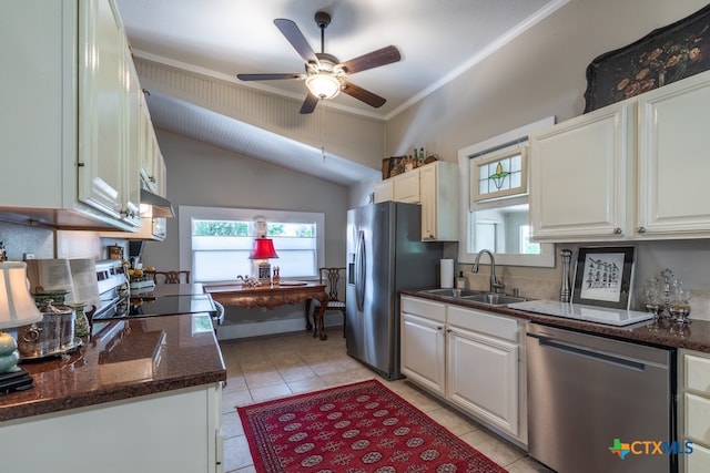 kitchen with stainless steel appliances, white cabinets, sink, crown molding, and dark stone countertops