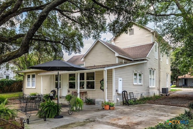 rear view of property featuring central AC