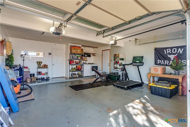 garage featuring washer / dryer and a garage door opener