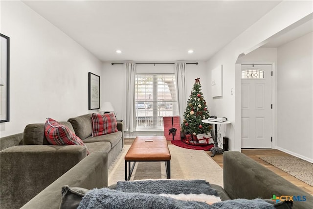 living area with recessed lighting, baseboards, and wood finished floors